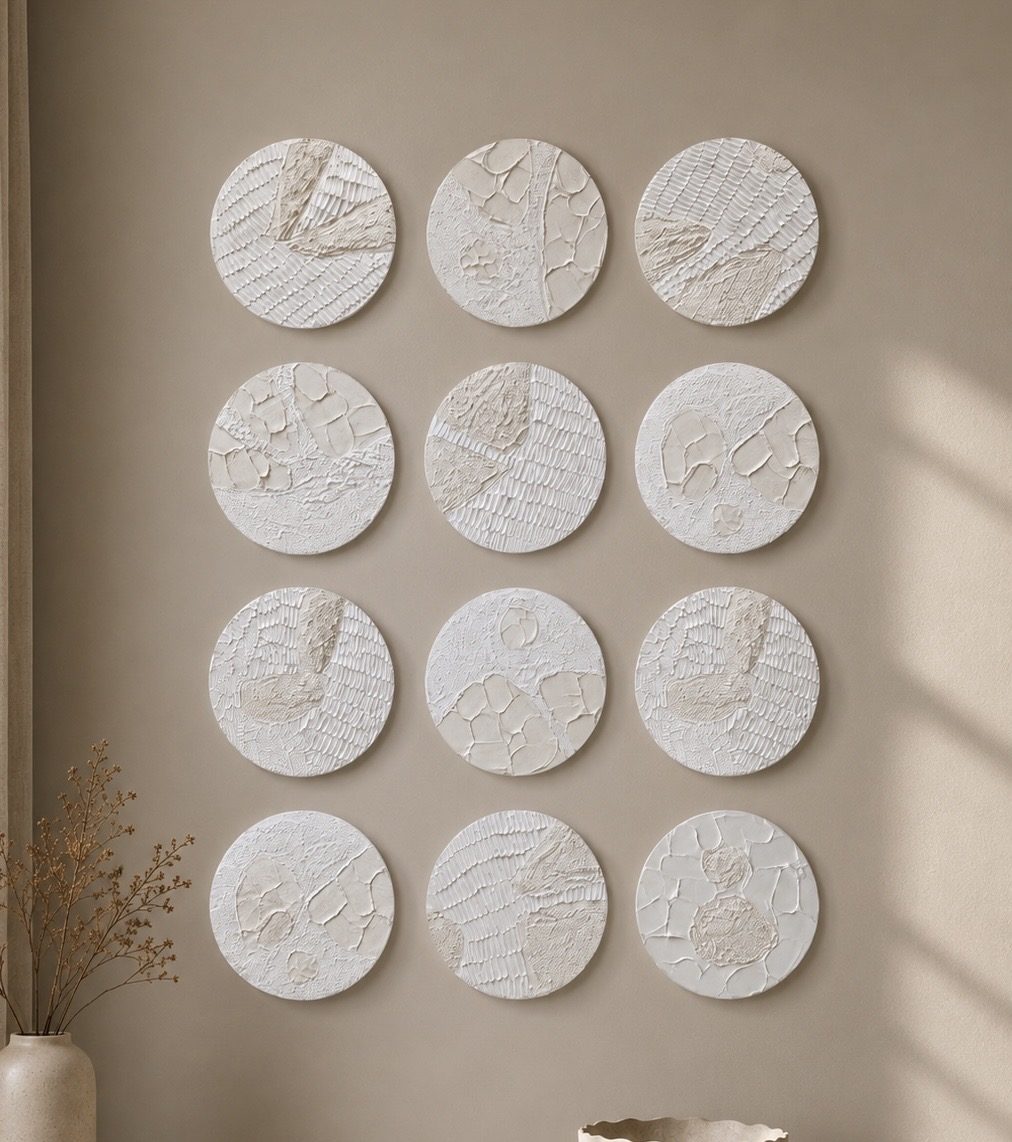 Twelve circular plaster relief discs on a wall